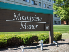 Mountain View Manor sign with greenery